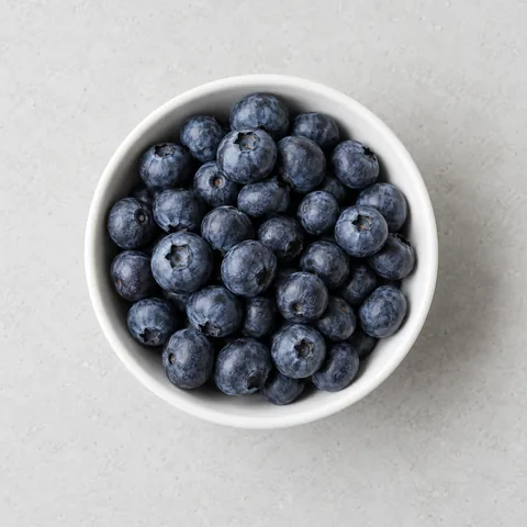Fresh blueberries in a small white bowl.