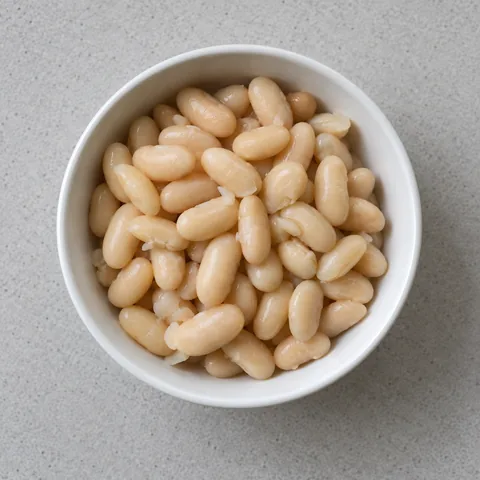 Drained and rinsed cannellini beans in a white bowl.
