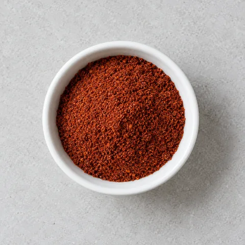 Chili powder in a small white ramekin.