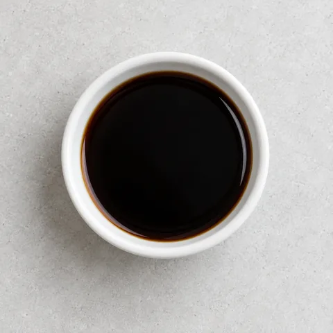 Chinkiang black vinegar in a small white ramekin.