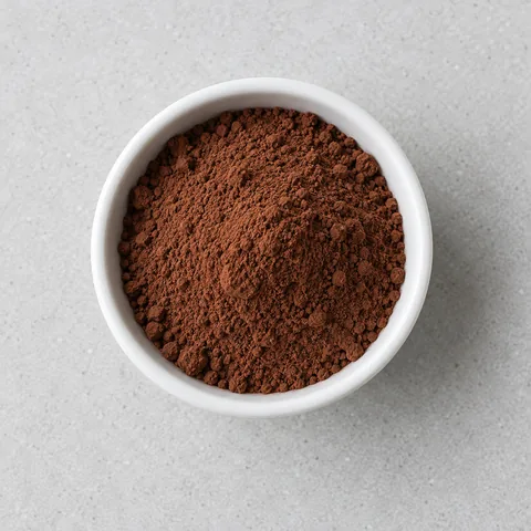 Unsweetened cocoa powder in a small white ramekin.