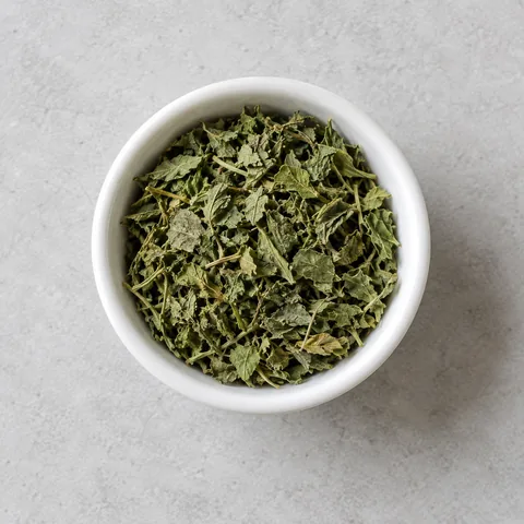 Dried fenugreek leaves (kasuri methi) in a small white ramekin.
