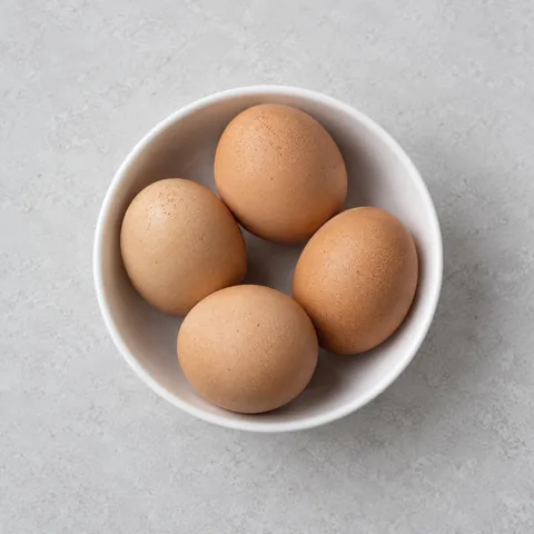 Large eggs in a small white bowl.