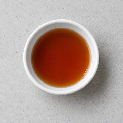 Fish sauce in a small white ramekin.