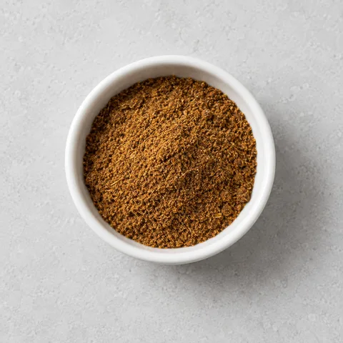 Garam masala in a small white ramekin.