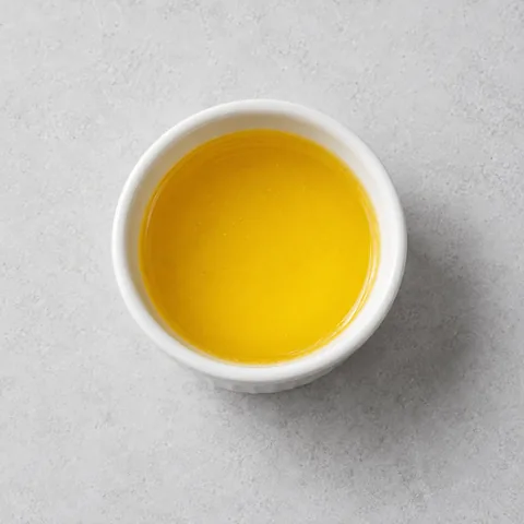 Melted ghee in a small white ramekin.