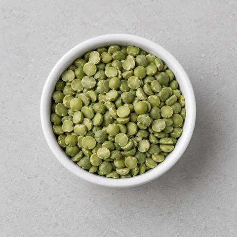 Dried green split peas in a small white ramekin.