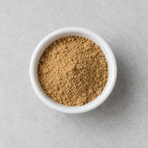 Ground coriander in a small white ramekin.