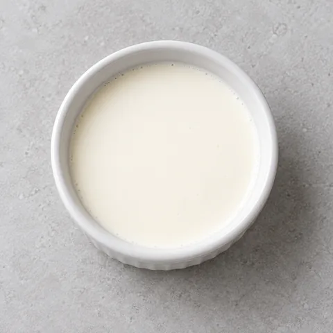 Half-and-half in a small white ramekin.