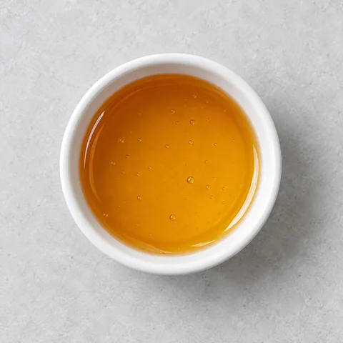 Honey in a small white ramekin.