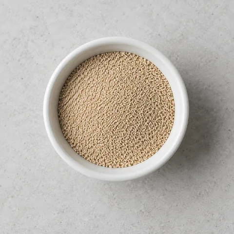 Instant yeast in a small white ramekin.