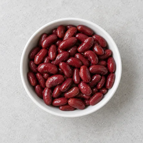 Canned red kidney beans, drained and rinsed in a small white bowl.