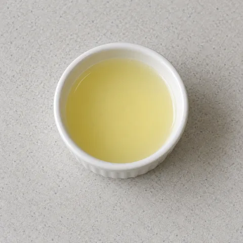 Strained lemon juice in a white bowl.
