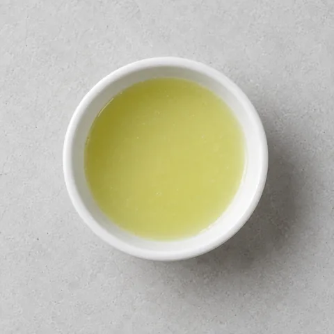 Fresh lime juice in a small white ramekin.