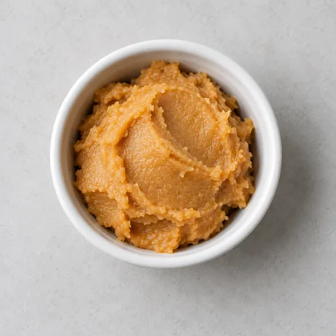 Miso paste in a small white ramekin.