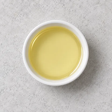 Neutral cooking oil in a small white ramekin.