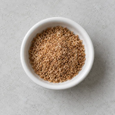 Freshly grated nutmeg in a small white ramekin.