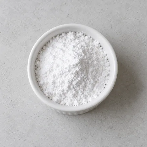 Powdered sugar in a small white ramekin.