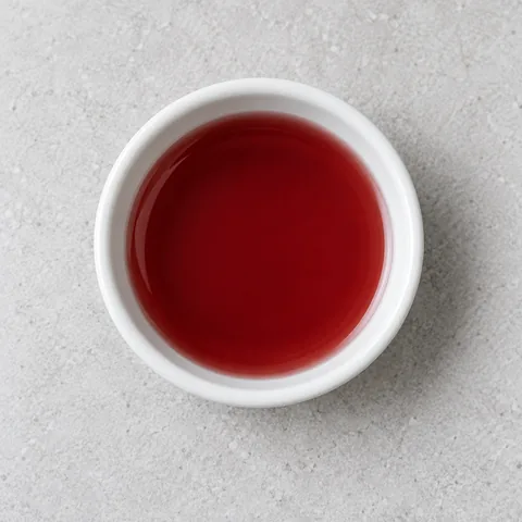 Red wine vinegar in a small white ramekin.