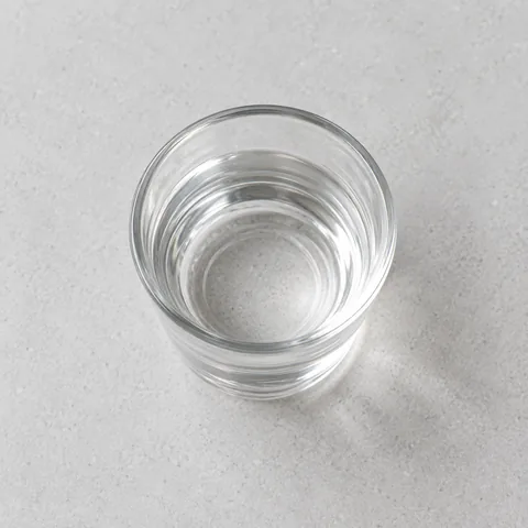 Rose water in a small clear glass.