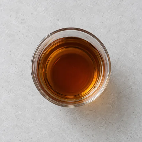 Shaoxing rice wine in a small clear glass.