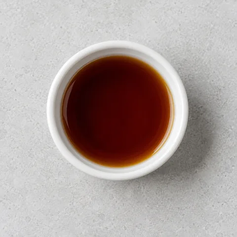 Sherry vinegar in a small white ramekin.