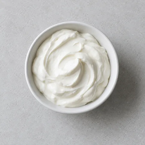 Sour cream in a small white bowl.