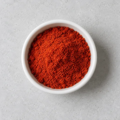 Sweet paprika in a small white ramekin.