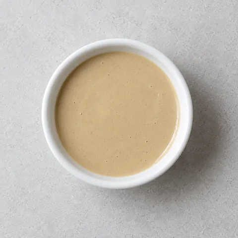 Tahini in a small white ramekin.