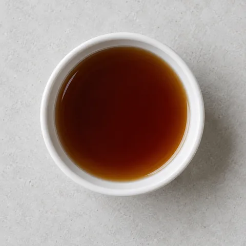 Vanilla extract in a small white ramekin.