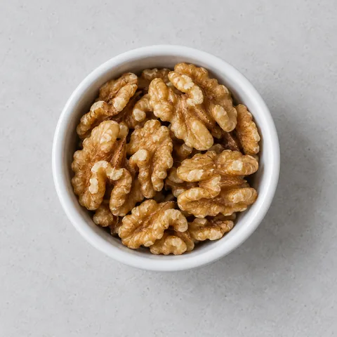 Walnut halves in a small white ramekin.