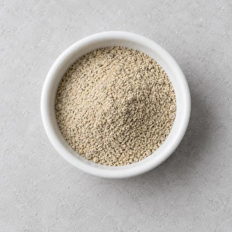 Ground white pepper in a small white ramekin.