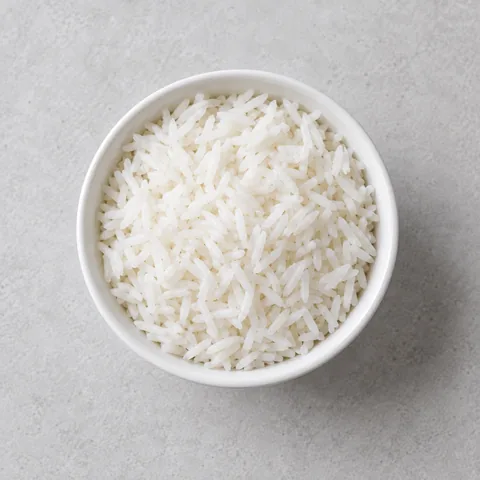 Cooked long-grain white rice in a small white bowl.