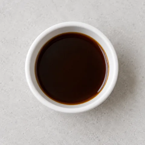 Worcestershire sauce in a small white ramekin.