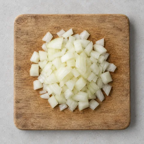 Chopped yellow onion on a wooden cutting board.