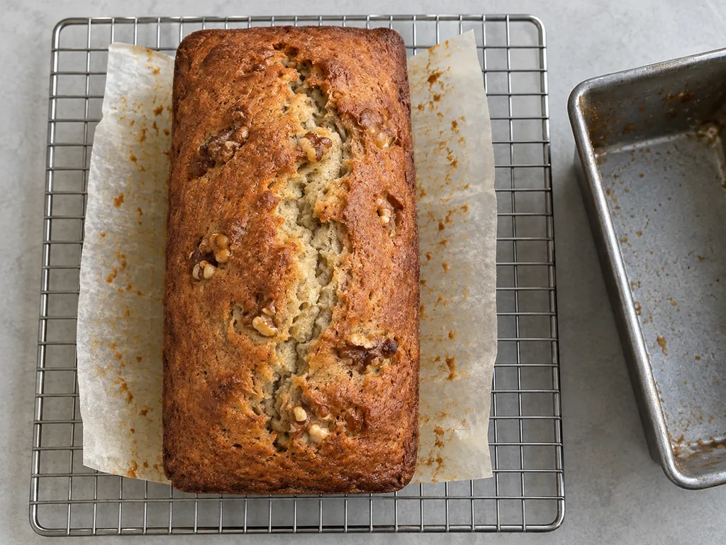 Lift out and cool. Lift the loaf out by the parchment and cool it on the rack until the bottom feels cool to the touch, about 60 minutes or longer.