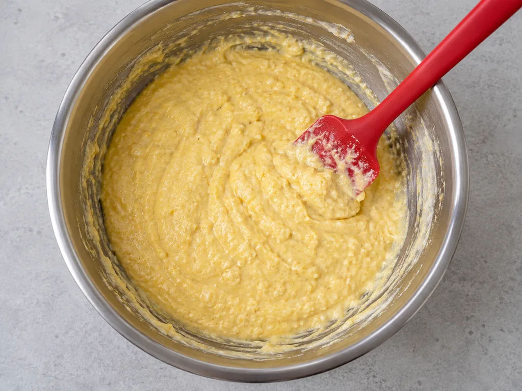 Pour and stir. The batter is thick but pourable, with a few small lumps.