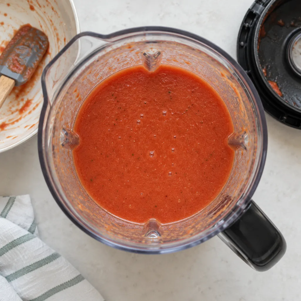 Vegetables and their juices blended smooth with only tiny flecks remaining.