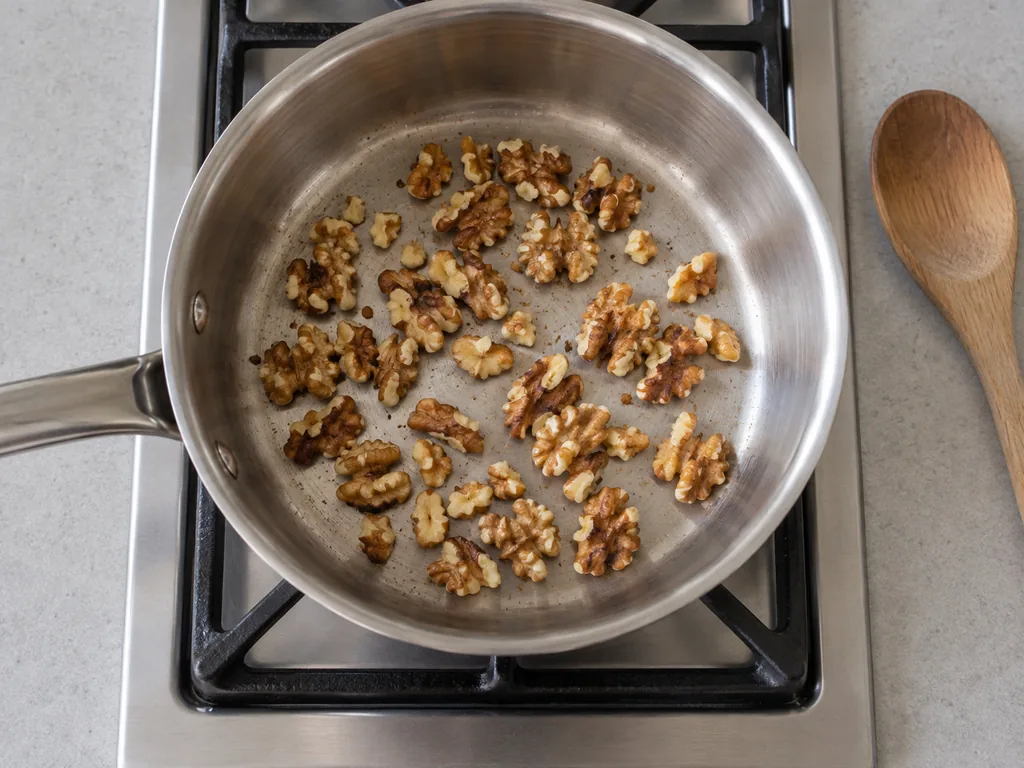 Toast the walnuts — The walnuts smell toasty and have darkened a shade.