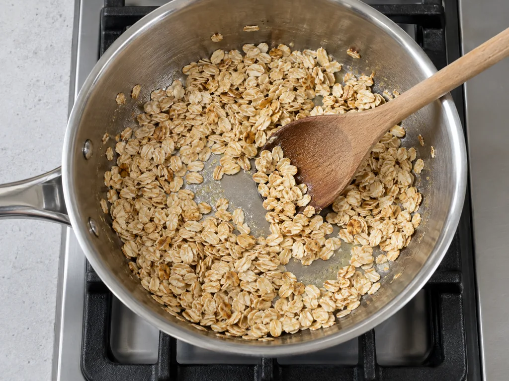 Melt butter and toast oats — The oats smell nutty and have light golden edges.