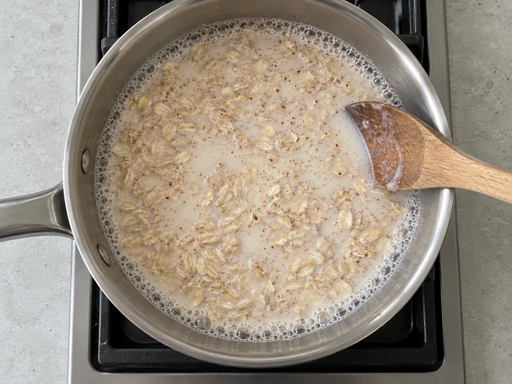 Pour in the liquids — The edges bubble steadily before the heat is lowered.